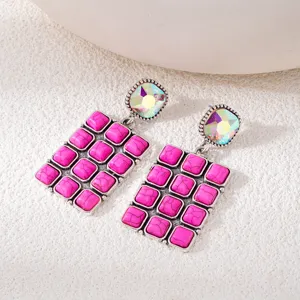 Close-up detail of vintage style pink turquoise grid earrings with colorful crystal studs.
