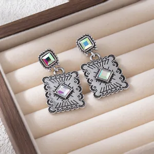 Vintage style geometric drop earrings with iridescent crystal stones detailed shot.