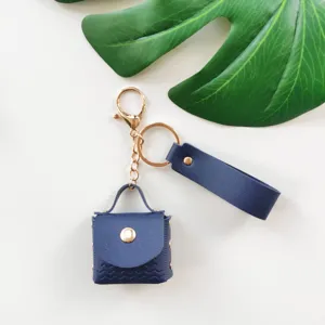 Portachiavi mini borsa in pelle PU, anello monocolore con cinturino, accessorio elegante.