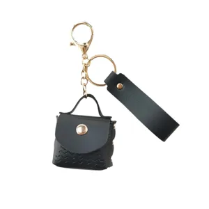 Portachiavi borsa mini in ecopelle PU con dettagli dorati e cinturino nero elegante.