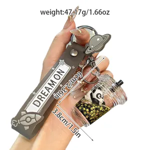 Details of the cute cartoon liquid boba milk tea keychain with floating glitter panda pendant.