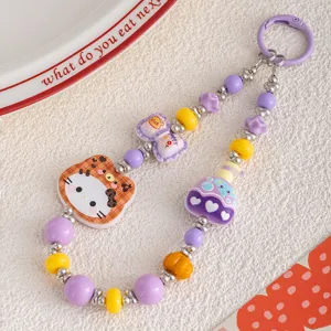 Detailed view of a cute colorful cat beaded phone charm and sweet bag pendant accessory.