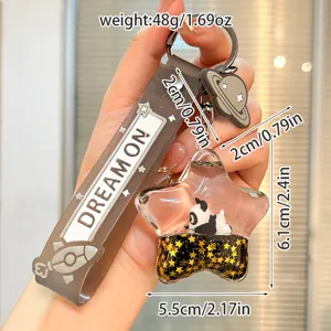 Close-up of cute star liquid panda keychain with sparkling glitter and strap. Detail view.