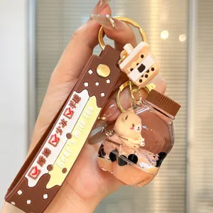 Cute boba milk tea liquid quicksand bottle keychain with bear pendant, stylish bag accessory.