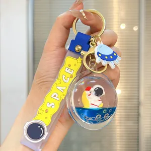 Astronaut liquid quicksand keychain detail, clear floating sphere with cute space pendant charm.