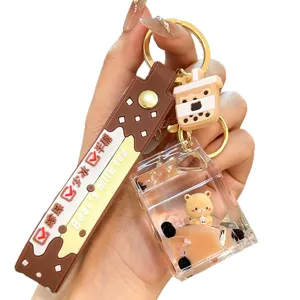 Cute boba milk tea liquid quicksand keychain detail view, acrylic bear charm, bag pendant.