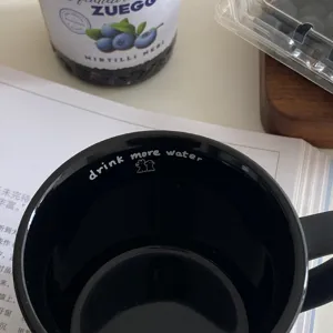 Matte black ceramic coffee mug with cute puppy print, stylish minimalist water cup for couples.