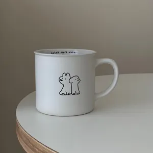 Detailed close-up shot of the white ceramic mug, featuring a cute dog illustration and text.
