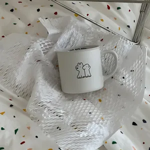 Minimalist white ceramic coffee mug featuring cute puppy line art, ideal daily use.