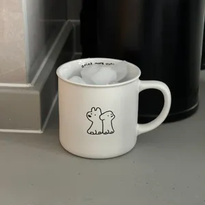 Matte ceramic coffee mug featuring cute dog illustration and inner rim text, 320ml capacity.