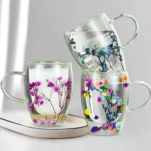 Double wall glass cup with colorful dried flowers inside, clear coffee mug for gift.