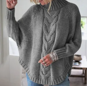Close-up detail view of women's cozy gray cable knit turtleneck batwing sleeve sweater.