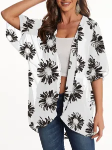 Detail shot of lightweight floral chiffon kimono cardigan, sheer fabric and black print.