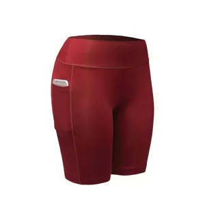 Close-up detail of high waist yoga shorts with convenient side pocket in deep red color.