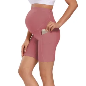 Side detail view of high waist maternity yoga shorts featuring a side phone pocket.