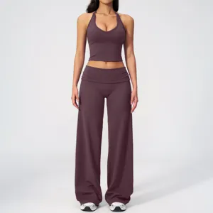 Detail view of the deep purple halter yoga top and wide-leg trousers, soft activewear fabric.