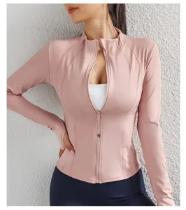 Pink slim-fit athletic zip-up jacket detail showing curved panel seams and high collar.