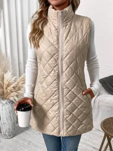 Detail view of a beige quilted puffer vest, mock neck, diamond pattern, stylish sleeveless outerwear.