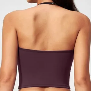 Back detail of women's halter yoga crop top, solid stretch fitness activewear garment.