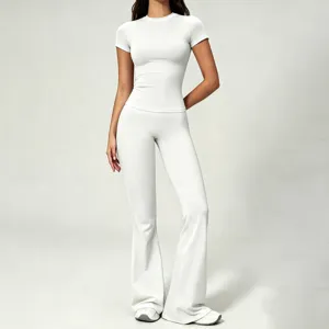 Detailed view of the women's white short sleeve fitted top and high waist flared yoga pants set.