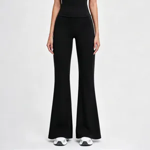 Details of high-waisted black flare yoga pants showing slim fit, elastic waist and stylish cut.