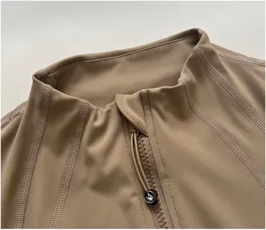 Close-up view of a khaki women's sports jacket collar, featuring stretch fabric and zipper design.