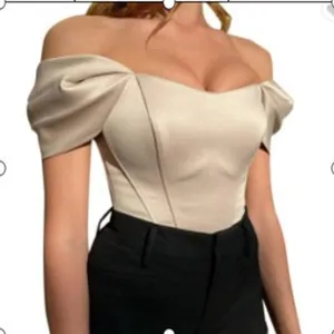 Off-shoulder satin corset top detail featuring stylish puff sleeves and structured boning.
