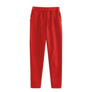 Detail view of red fleece-lined sweatpants with comfortable drawstring waist and pockets.