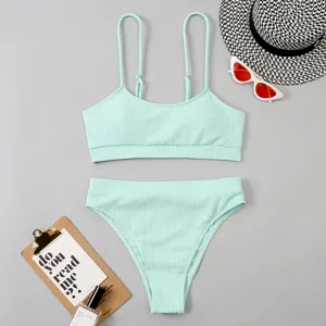 Détail de bikini côtelé vert menthe: haut col U et bas taille haute avec des accessoires.