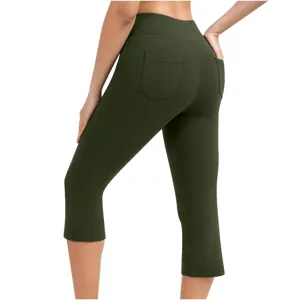 Detail view of women's high waist yoga capri pants in dark green with back patch pockets.