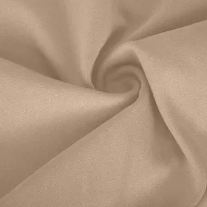 Close-up detail of soft stretchy solid khaki yoga pants fabric texture and smooth material.