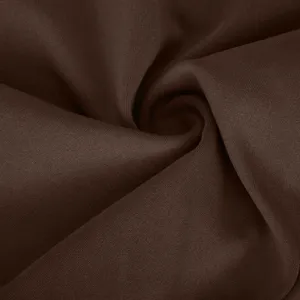 Detailed view of dark brown yoga pants fabric texture, premium stretch knit material.