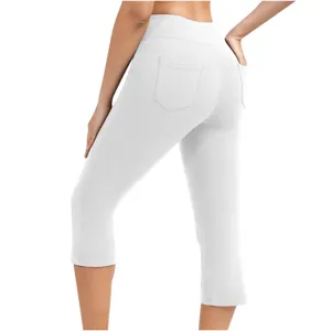 Detail shot of white high-waisted yoga capri pants with back pockets, showing fit and fabric.