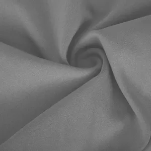 Detailed shot of high stretch solid gray yoga pants fabric, showing soft texture.