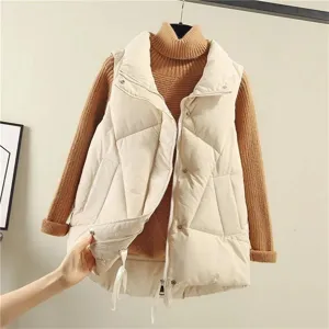 Closeup of stylish women's beige puffer vest with stand collar, quilted design and zipper.