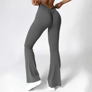 Back view detail of high-waist V-waist scrunch butt flared yoga pants in solid gray color.
