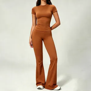 Brown short sleeve top and flare yoga pants detail view, brushed bare feel fabric texture.