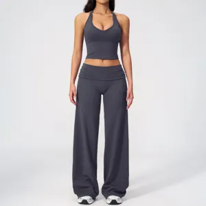 Dark grey halter yoga set with crop top and foldover wide-leg pants for fitness gym.