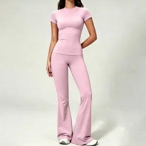 Pink short sleeve top and high waist flare yoga pants set detail, soft fabric activewear.