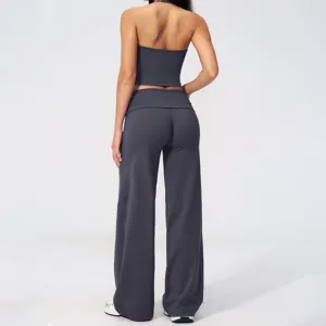 Back view detail of dark gray halter crop top and fold-over wide leg yoga pants set.