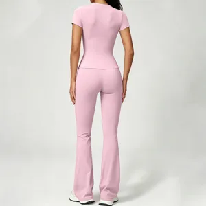 Pink yoga set for women, featuring a slim fit short sleeve top and high waist flared pants.