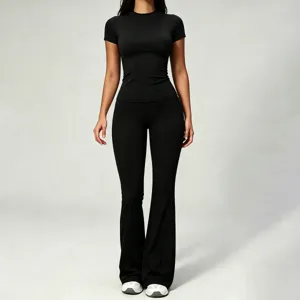 Black short sleeve top and high waist flared yoga pants set for women fitness wear.