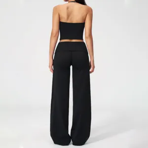 Back view detail of the black halter crop top and high waist wide leg yoga pants set, elegant.