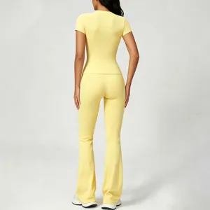 Detail view of the yellow bare-feeling yoga set, slim fit short sleeve and flared pants.