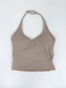 Halter neck yoga top detail view, sleeveless fitness crop top with v-neck and strap.
