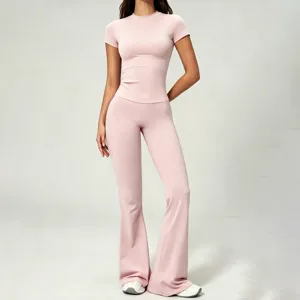Close-up details of pink slim-fit short-sleeve top and high-waist flare yoga pants set.