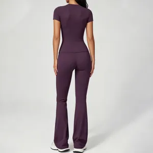 Detail view of the purple yoga outfit back, featuring slim short sleeves and flare pants.