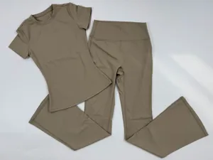 Sanded nude yoga set detail, slim fit short sleeve top and high waist flared pants for fitness.