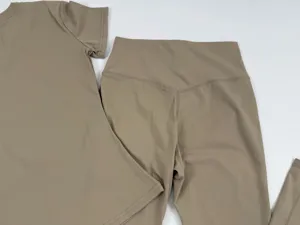 Khaki brushed bare-feeling yoga set detail, featuring short sleeve top and high waist flared pants.