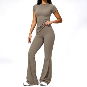 Women's seamless ribbed athletic yoga set, short sleeve top and high waist flared pants.